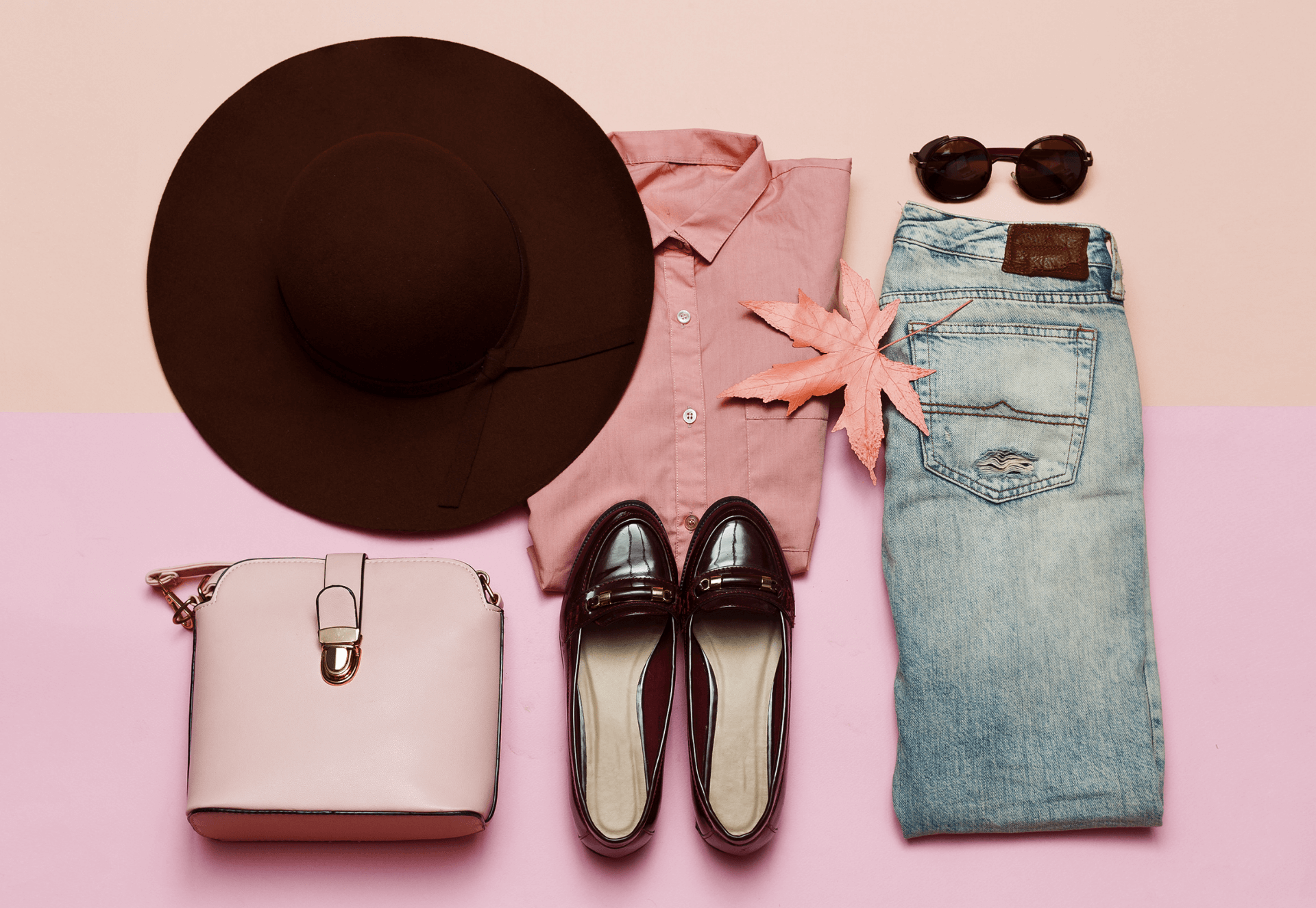 Image of a fashion flat lay showing jeans, shoes a hat, top and sunglasses.