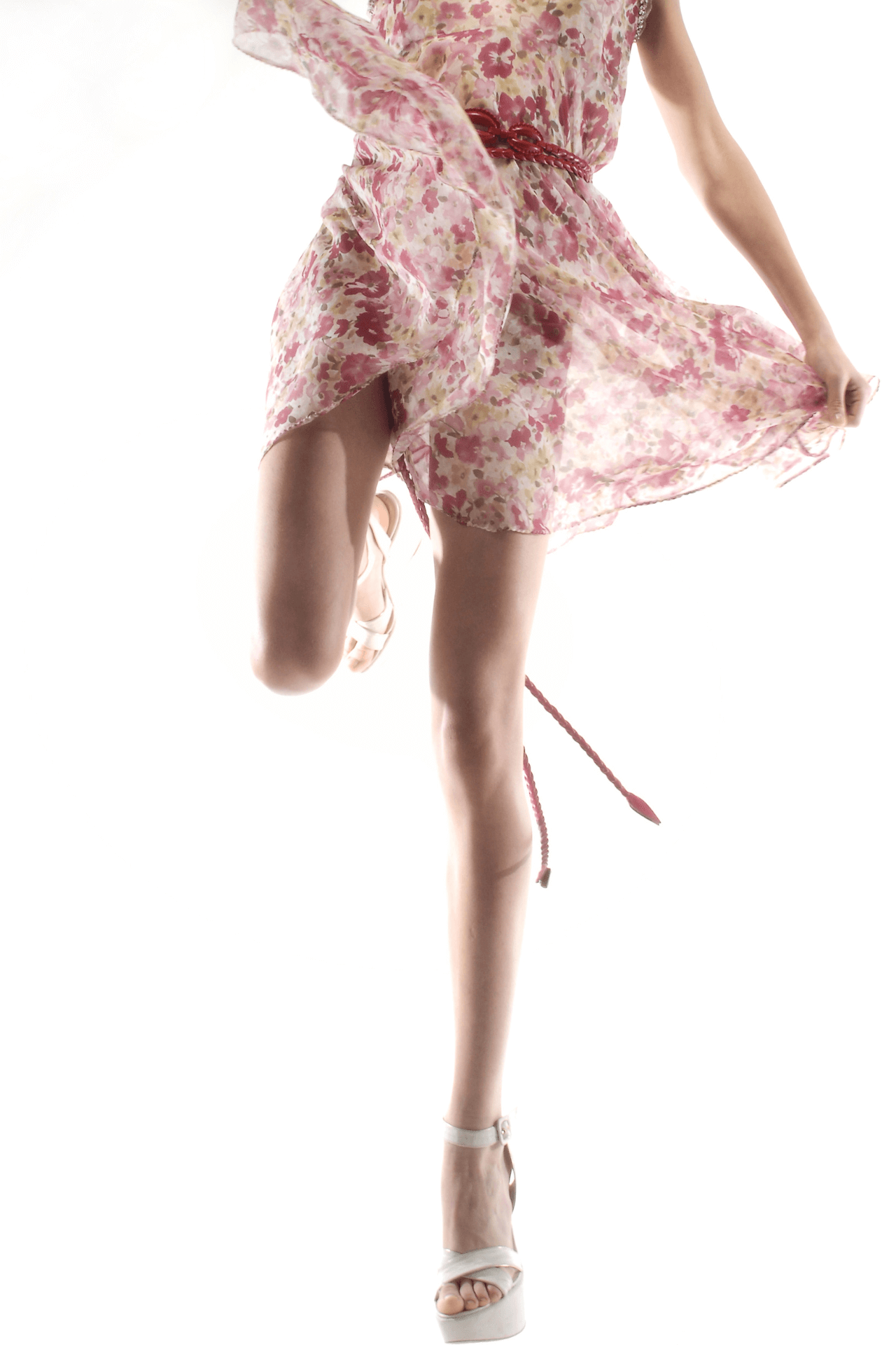 image of a woman standing on one leg wearing a lightweight pale pink dress and pale high heeled shoes.